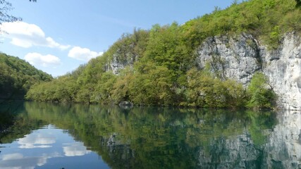 Plitvice Lakes - mirroring the sky with clouds and rocks on the lake surface - Croatia - May - 2022