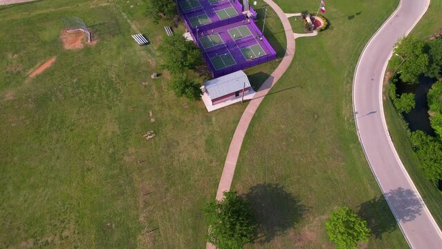 Aerial footage of Bear Creek Park in Keller Texas.  Camera shows tennis court