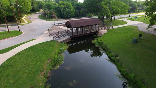 Aerial footage of Bear Creek Park in Keller Texas.  East part of the park and bridge crossing the creek.