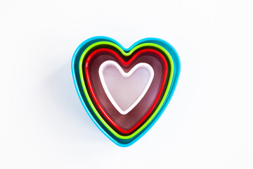 Heart shaped plastic cookie cutter isolated on white background.