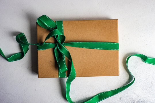 Overhead view of a gift box tied with a green ribbon