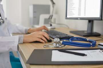 Medicine doctor's working table. Doctor's workspace working at computer and typing electronic...