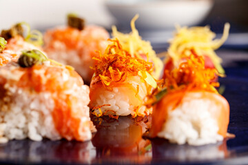 baked hot sushi rolls on a dark background. Hot fried Sushi Roll Sushi menu Set of sushi food with...