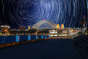 Fototapeta premium Star trails in the sky over Sydney Harbour NSW Australia startrails. lovely patterns and beautiful colours of the night.