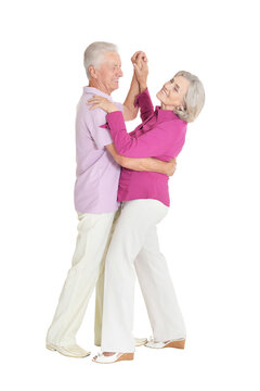 Portrait of senior couple dancing on white background
