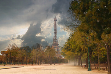 Fototapeta na wymiar Eiffel Tower and Cloudy Sky from Sandy Windy Park