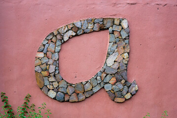 A wall with the letter A design is seen 
