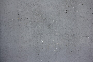 Gray old battered metal wall with cracks is an abstract background texture of the loft.