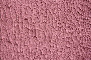 New pink-painted concrete surface close-up. The texture of the background for the wallpaper.