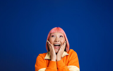 Asian girl with pink hair and piercing expressing surprise at camera