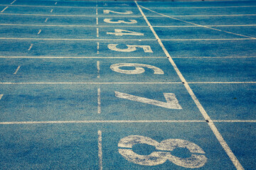 Blue treadmill at the stadium with the numbering from one to eight 