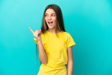Little girl over isolated blue background intending to realizes the solution while lifting a finger up