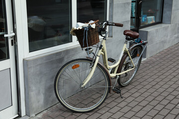 Vintage bicycle with basket near shop entrance