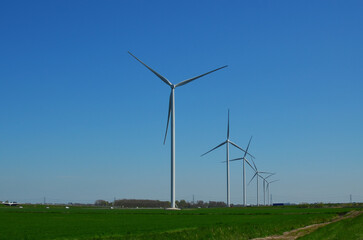 Beautiful view of countryside with wind turbines on sunny day. Alternative energy source