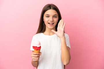 Little girl with a cornet ice cream over isolated pink background shouting with mouth wide open