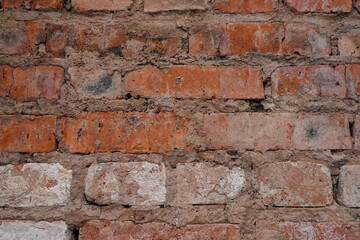 Red brick wall background with cracks between bricks
