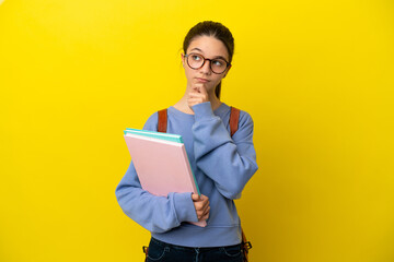 Student kid woman over isolated yellow background and looking up