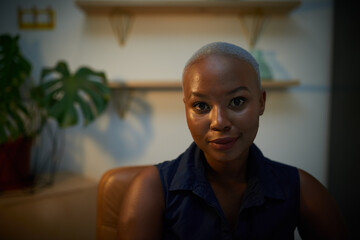 A moody portrait of a businesswoman in the office late at night