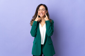 Young caucasian woman isolated on purple background smiling with a happy and pleasant expression