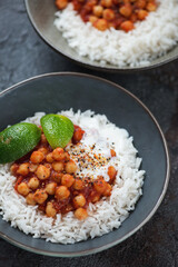 Chana masala or indian curried dish with chickpeas, onions, tomatoes, spices and herbs, close-up, vertical shot
