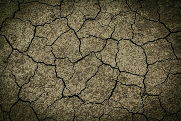 cracked earth texture in horror cinematic background. dark and scary picture, Halloween background, mysterious cracked surface photo. Dry ground