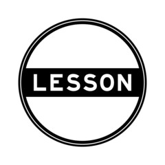 Black color round seal sticker in word lesson on white background