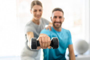 Fototapeta premium Modern rehabilitation physiotherapy woman worker with man client