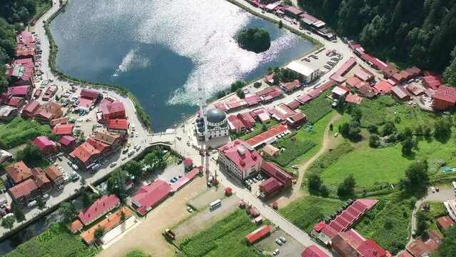 aerial drone circling over a mosque in a small village around the mountains of Uzungol Trabzon on a sunny summer day in Turkey.