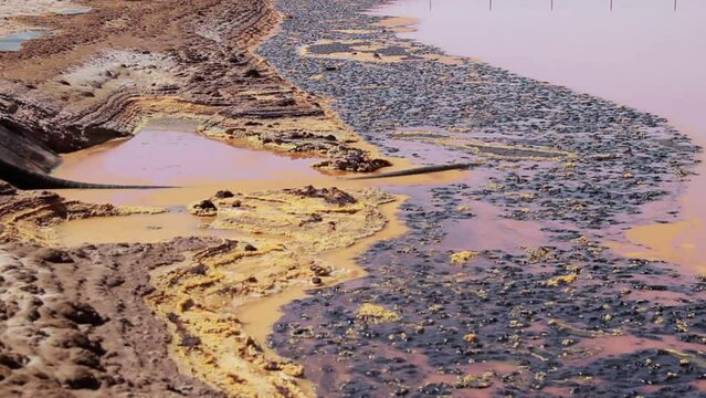 crude and waste near by oil site mixed with water and sand
