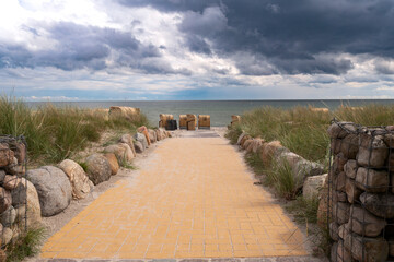 Beach access on the south beach on the island of Fehmarn in rain clouds