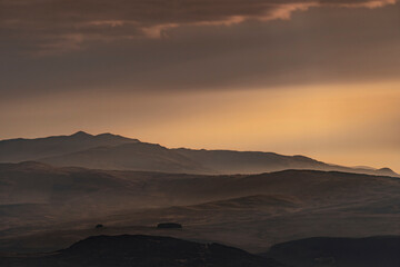 Snowdonia Wales morning landscape view with mist and orange sky