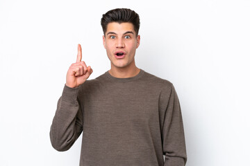 Young handsome caucasian man isolated on white bakcground thinking an idea pointing the finger up