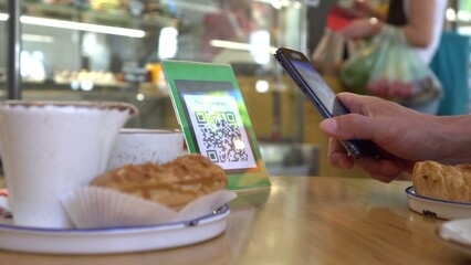 Smartphone scanning the recipients QR code. Mobile banking. Customers can pay through QR code, bank...