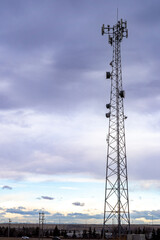 A cell phone tower and communications antenna at a natural park in Airdrie Alberta Canada.