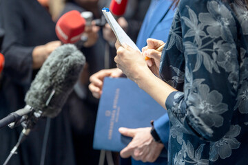 Journalist taking notes at media event, news or press conference. Journalism concept.