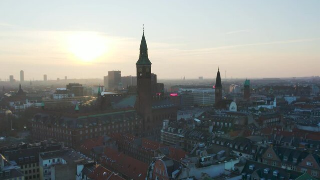 Drone panning down over copenhagen buildings and tower. 60fps