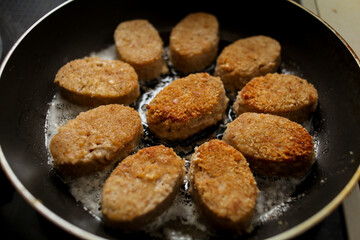 chicken cutlets fried in sunflower oil in a frying pan
