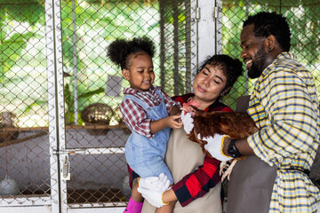 Happiness family farm and chickens farm.  A little girl learning farm from family.