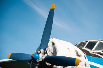 The propeller of a retro aircraft against the blue sky.