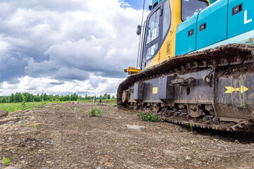 tracked construction machine on a stone-covered platform