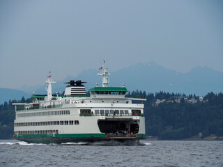 Washington State Ferry transiting Puget Sound with the Olympic Mountain range in the distance.