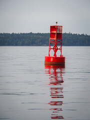 Isolated, large red buoy navigation marker in Puget Sound.  Red, right, returning.