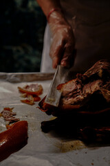 Chinese cook prepares Peking Roast Duck. Peking Duck is a famous duck dish from Beijing that has been prepared since the imperial era, and is now considered one of China's national foods.