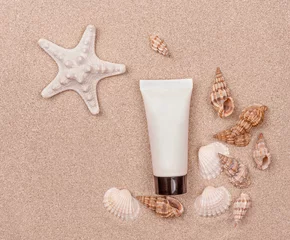  a suntan cream and seashells on sandy background © Albert Ziganshin