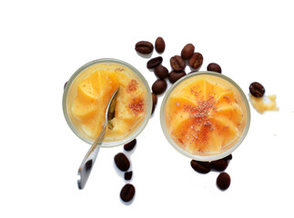 Orange mousse in a glass and roasted coffee beans
