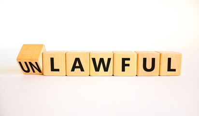 Lawful or unlawful symbol. Turned wooden cubes and changed the concept word Unlawful to Lawful. Beautiful white table white background, copy space. Business and lawful or unlawful concept.