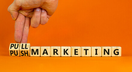 Pull or push marketing symbol. Businessman turns cubes and changes concept words Pull marketing to...