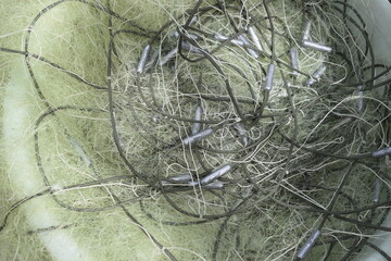 Fishing net with many lead weights, top view.