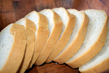 Sliced wheat white bread in a bread box.