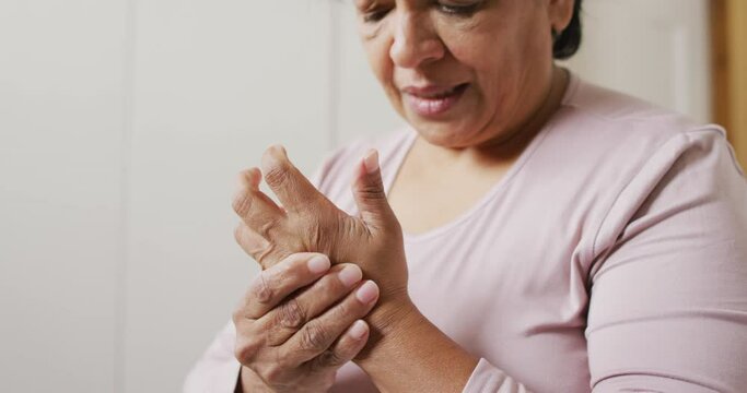 Close Up Of African American Senior Woman Holding Her Hand In Pain At Home